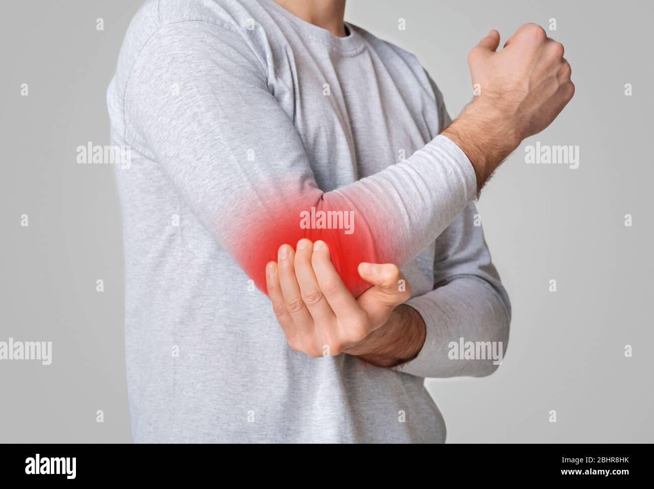 Sports trauma. Man suffering from pain in elbow Stock Photo Alamy
