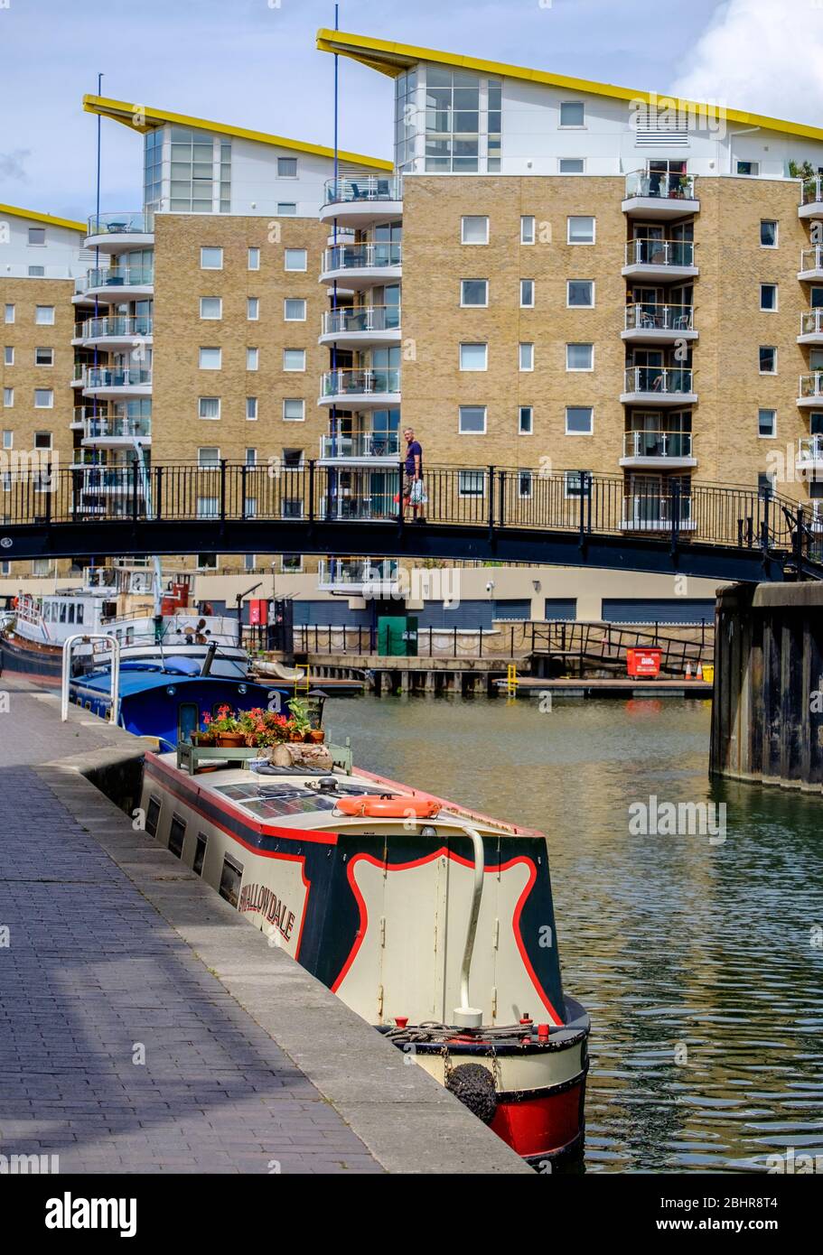 Moored boats at Limehouse Marina with tall residential buildings in the background. Tower  Hamlets, East London, England, UK Stock Photo