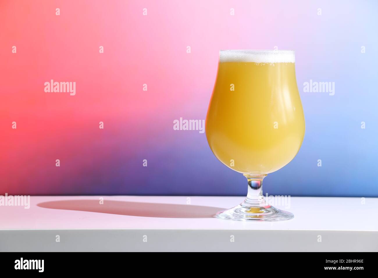 A hazy New England India pale ale beer in a tulip shaped glass against a soft background. Stock Photo