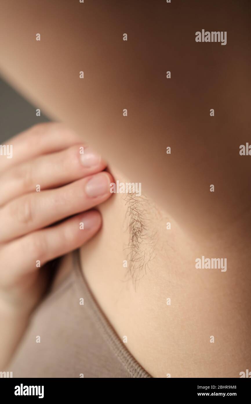 Hairy, unshaven female armpits. Concept of body positive and the adoption of its naturalness. Stock Photo