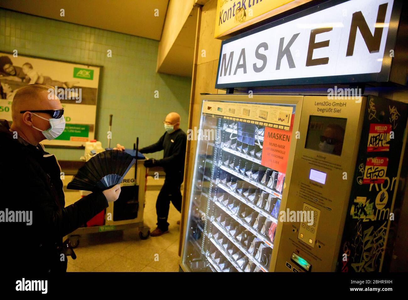 Berlin, Germany. 27th Apr, 2020. A man with a face mask looks at a