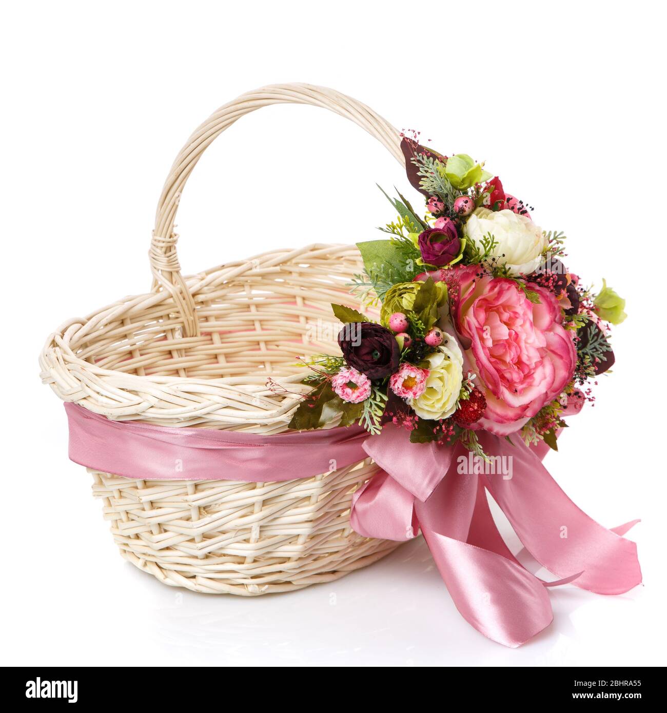 Wicker basket decorated with flowers on white background Stock Photo ...
