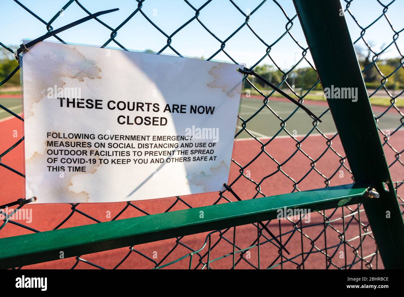 Tennis Courts Closed Sign Due to Coronavirus COVID-19 Pandemic Stock Photo