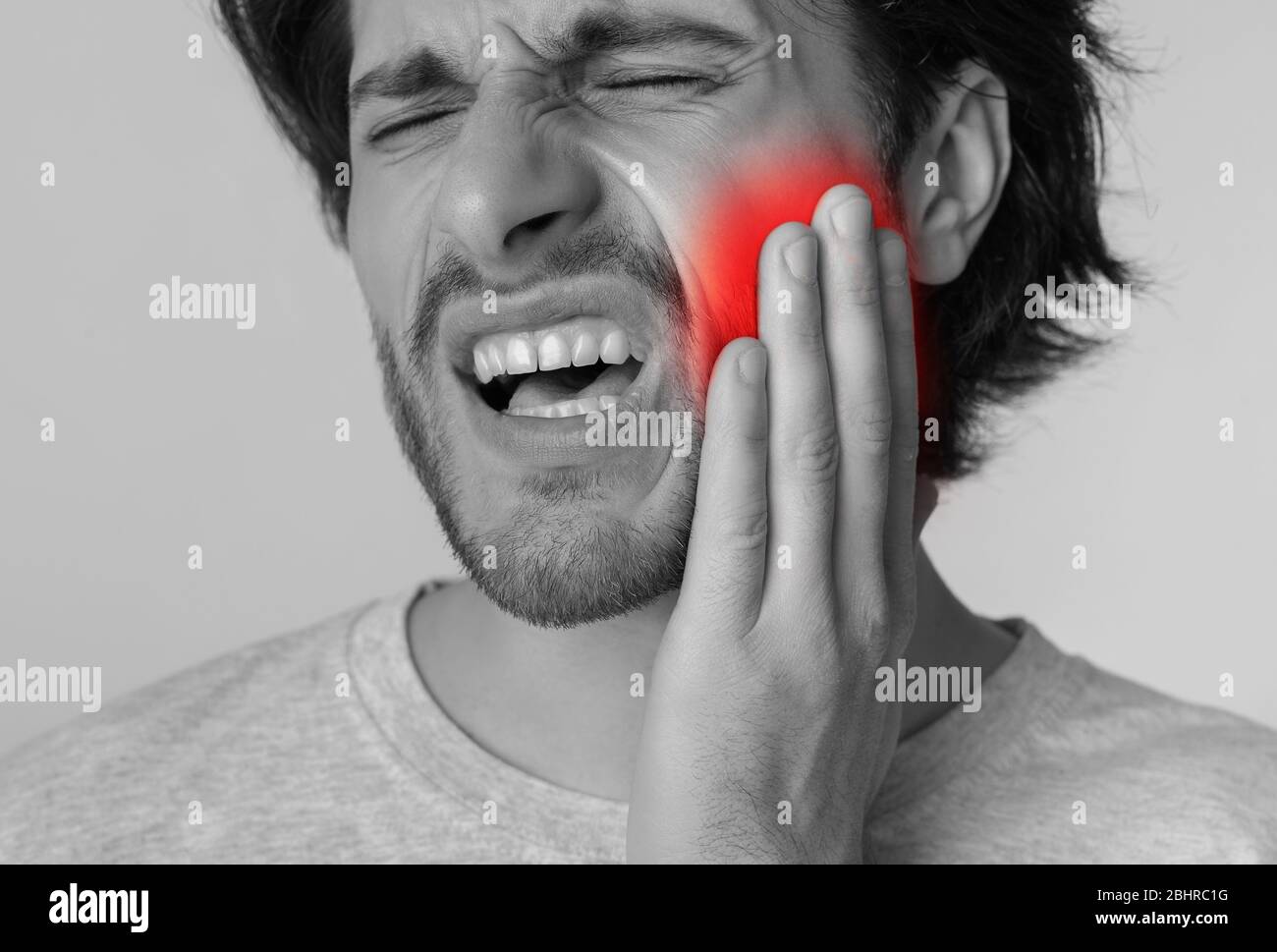 Tooth pain and dentistry concept. Man with painful expression Stock Photo