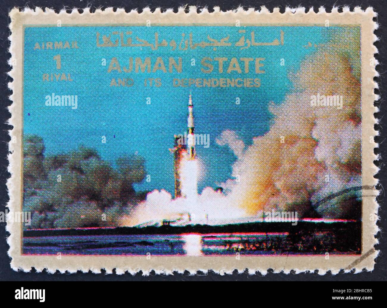 AJMAN - CIRCA 1973: a stamp printed in the Ajman shows Saturn V Rocket Launching, Moon-landing, Apollo 11, circa 1973 Stock Photo