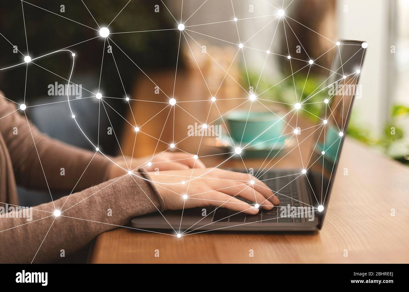 Woman using personal computer with flying network Stock Photo