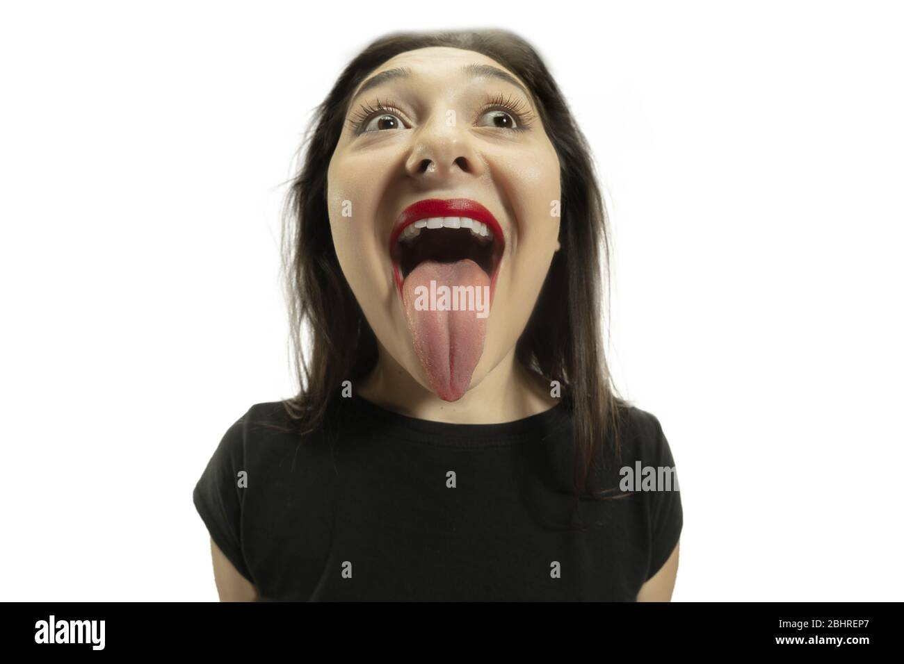 Smiling girl opening her mouth and showing the long big giant tongue