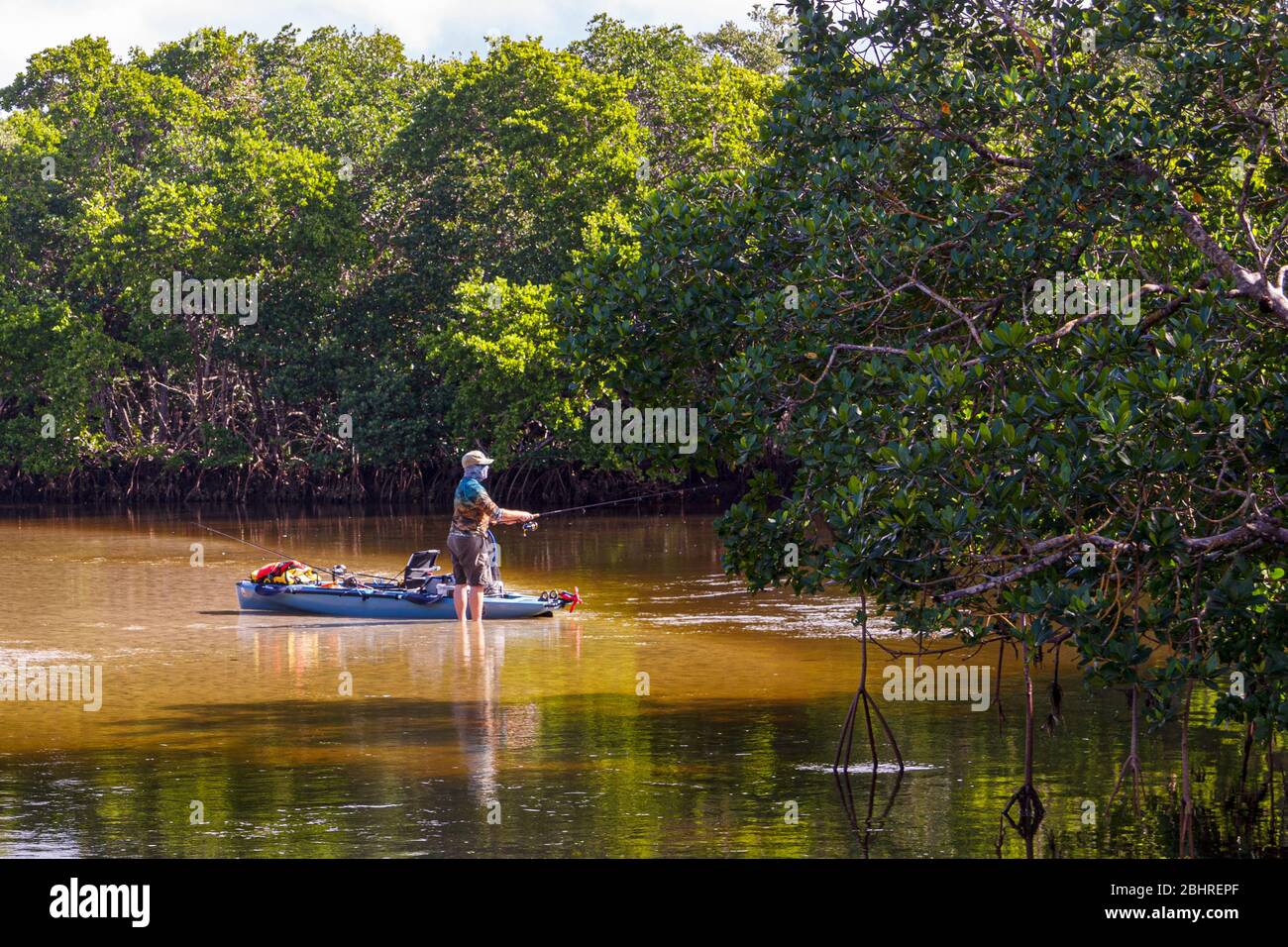 Solitary man fishing at a nature preserve Stock Photo
