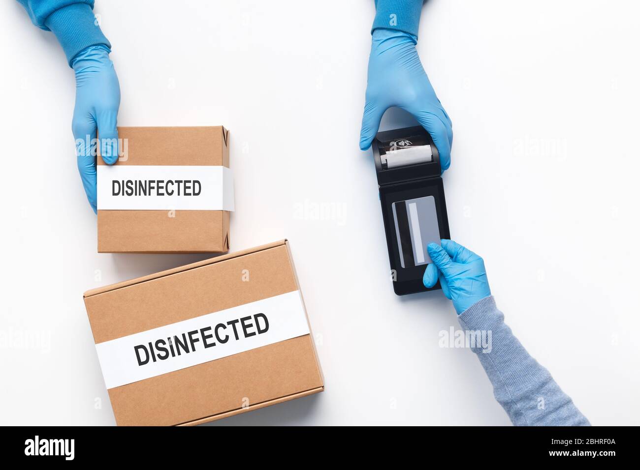 Delivery man holding cardboard boxes in medical rubber gloves Stock