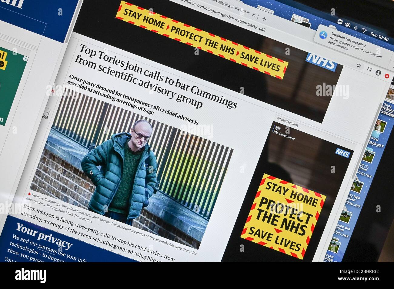 On-line public information Coronavirus/ Covid advert, 'Stay home, Protect the NHS' juxtaposed against an article and photo featuring Dominic Cummings. Stock Photo