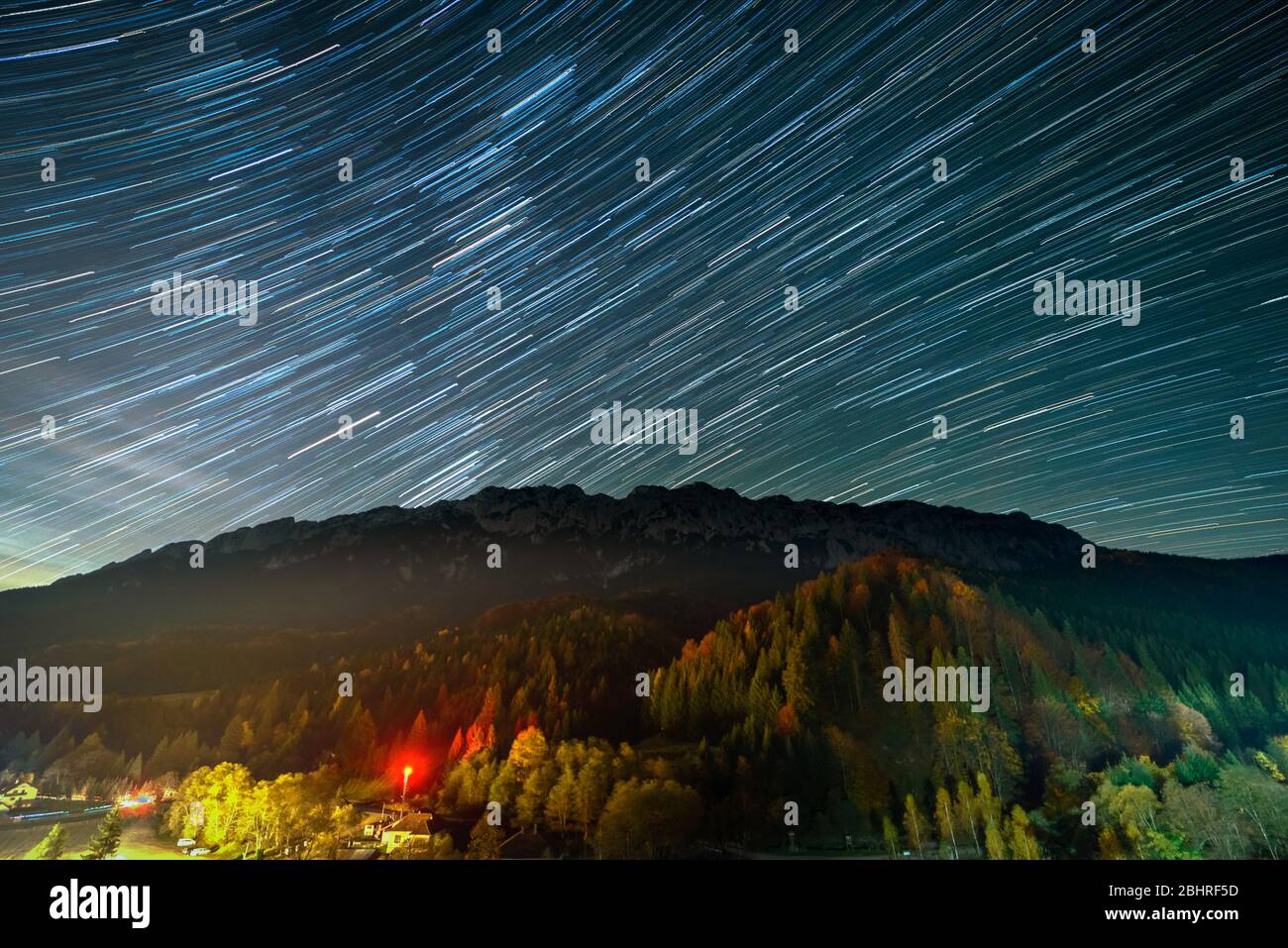 Star trails over the Plaiul Foii resort in Piatra Craiului mountains from Romania Stock Photo
