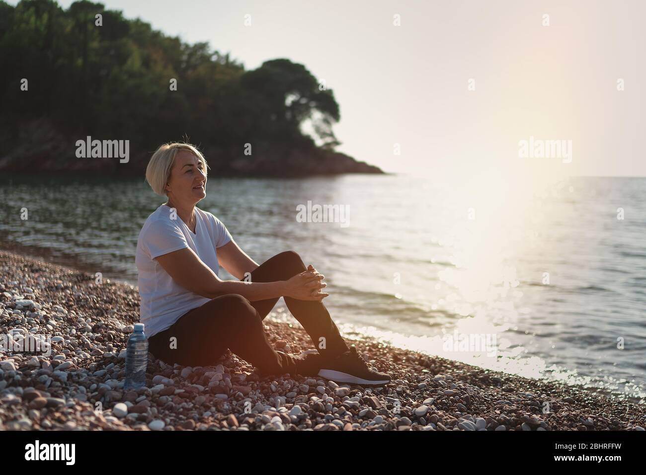 Mature woman relax sun beach hi-res stock photography and images - Alamy