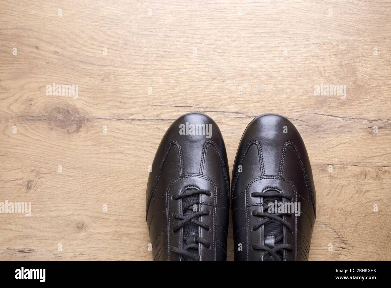 Black leather men shoes on wooden background Stock Photo - Alamy