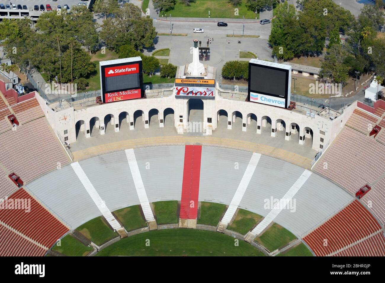 Aerial view of Los Angeles Memorial Coliseum, an Olympic Stadium with a football field. Empty sports stadium stands. LED panels visible. Stock Photo