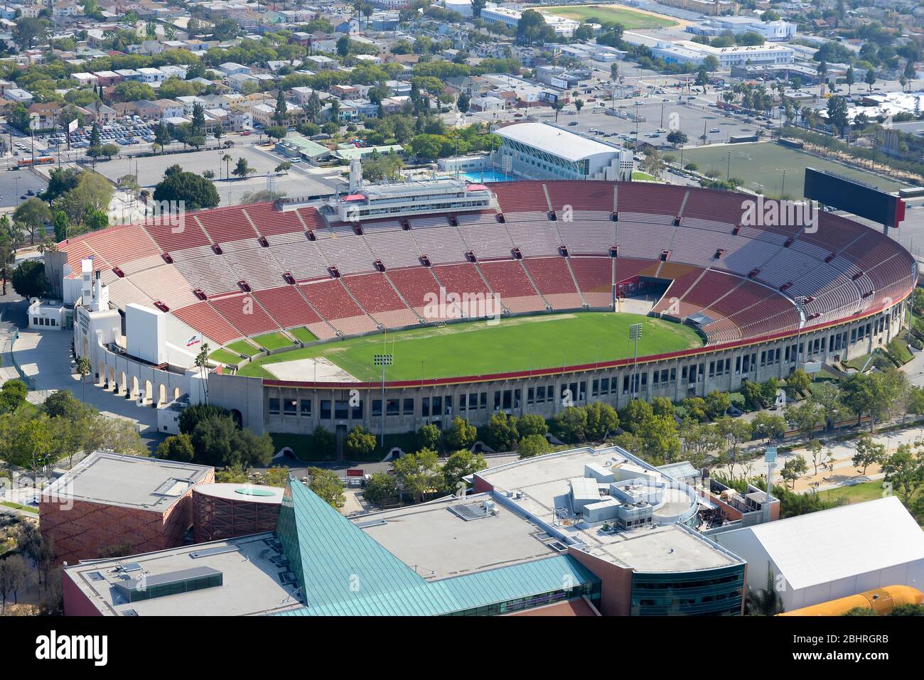 Aerial view of Los Angeles Memorial Coliseum, an Olympic Stadium with a football field. Empty sports stadium stands in California, United States. Stock Photo