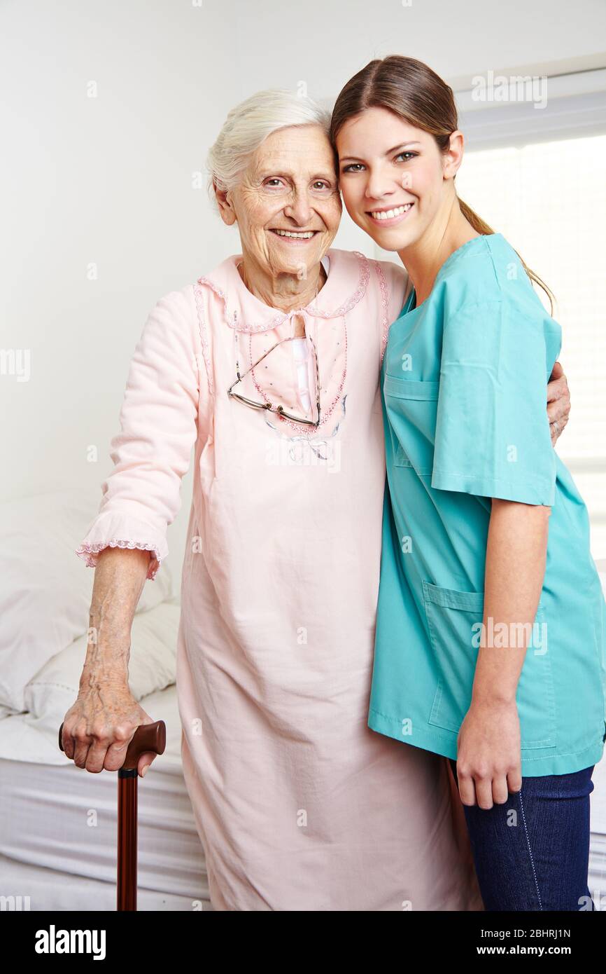 Smiling elderly woman stands hi-res stock photography and images - Alamy