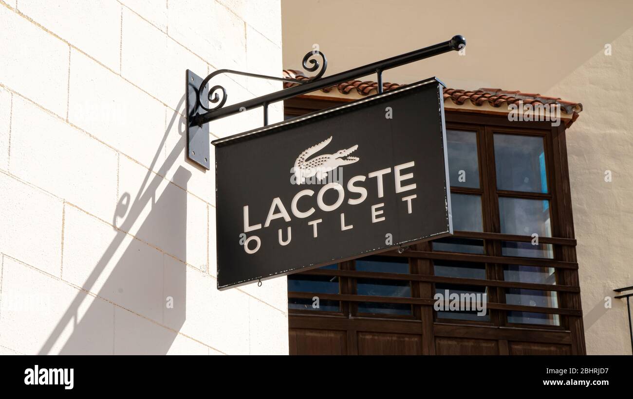 Palma de Mallorca, Spain - September 23, 2017: Lacoste outlet store sign. Lacoste is a french company selling clothing, footwear, sportswear, eyewear, Stock Photo