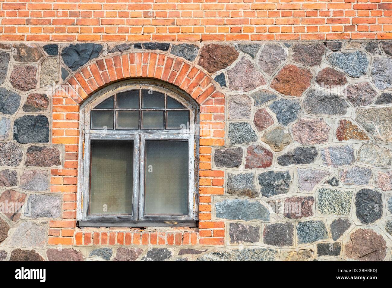 Stone and brick house wall with window. Janeda, Estonia Stock Photo