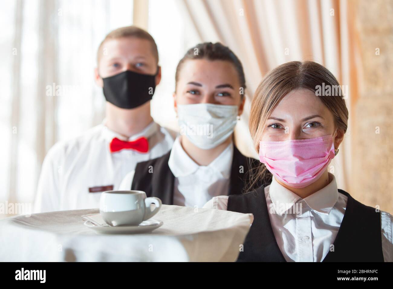 work of a waiter in a restaurant in a medical mask Stock Photo - Alamy