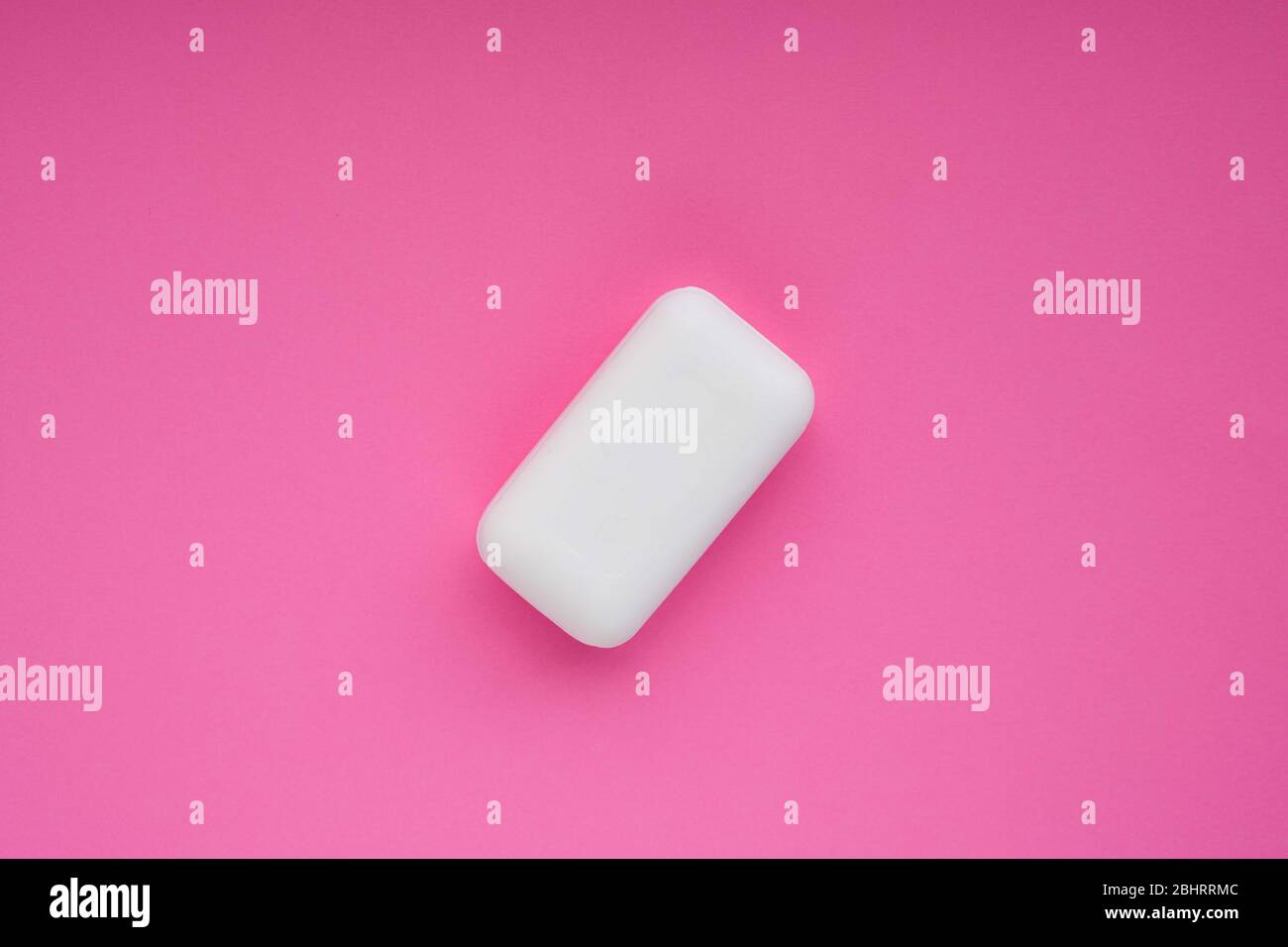 Bar of white soap on pink magenta background. Wash your hends concept. Stock Photo