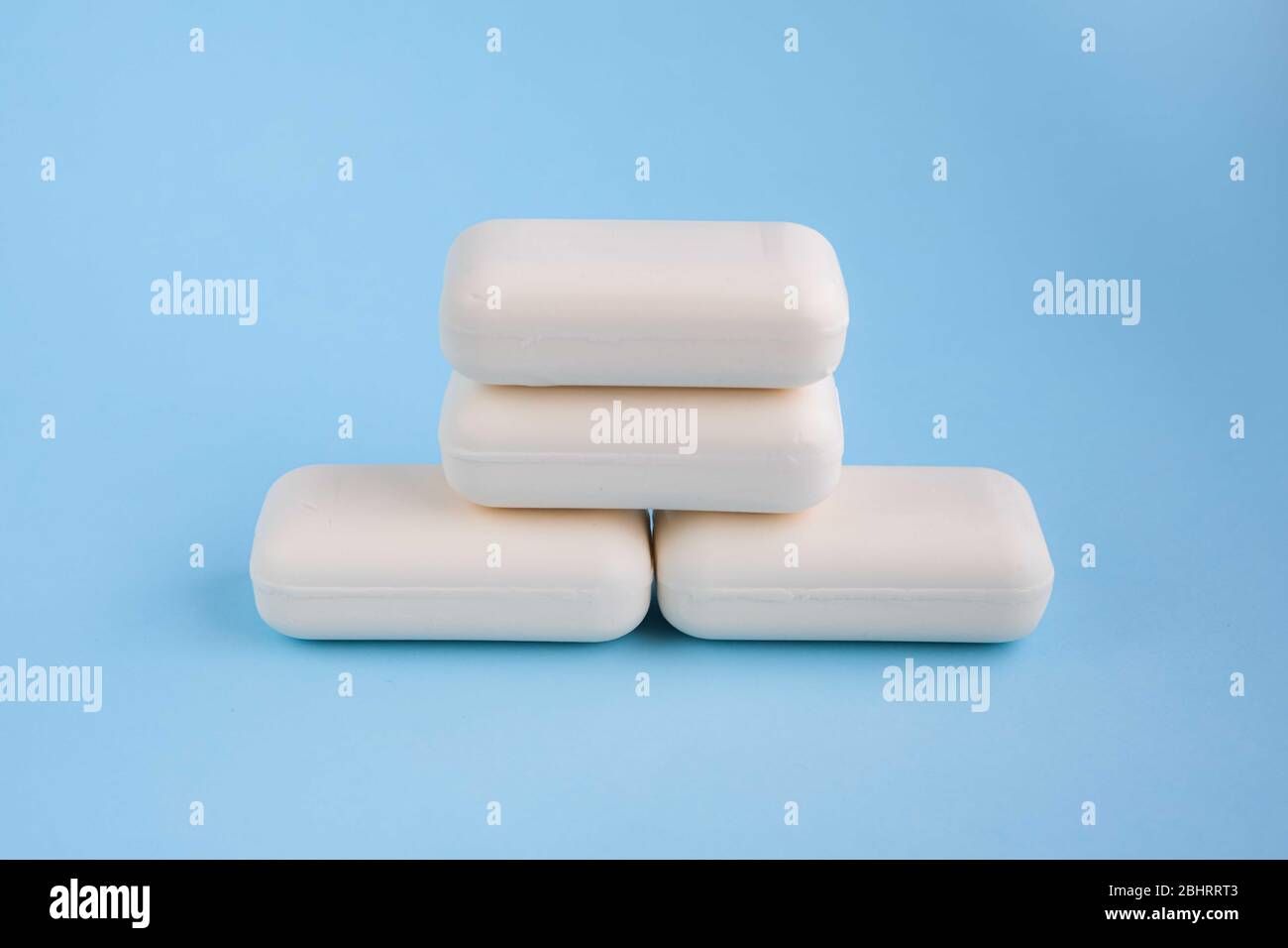 Bars of white soap on light blue background. Wash your hands concept. Stop bacteria or infection. Stock Photo