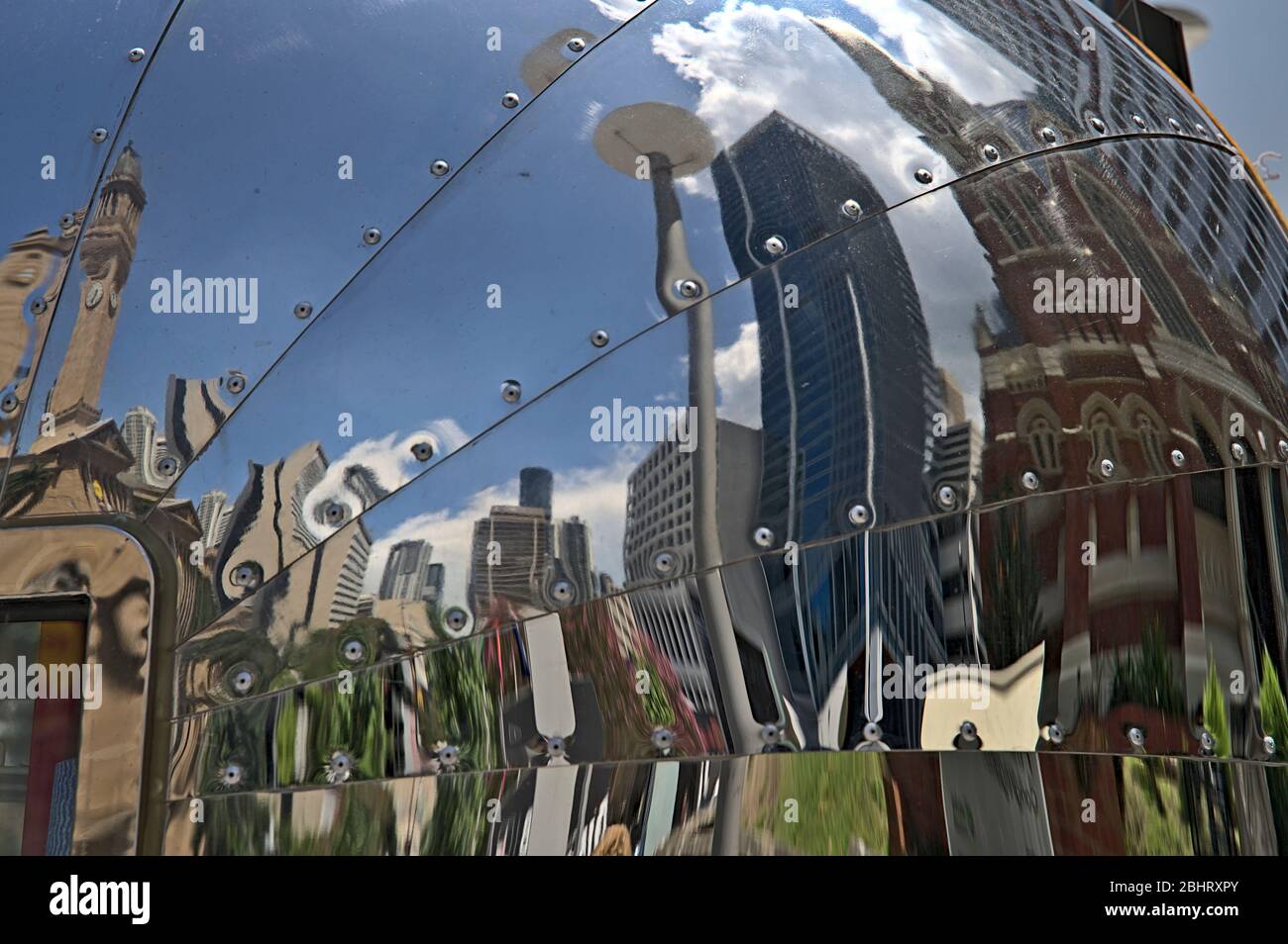 Some buildings of Brisbane as a reflection in the hull of a food truck Stock Photo