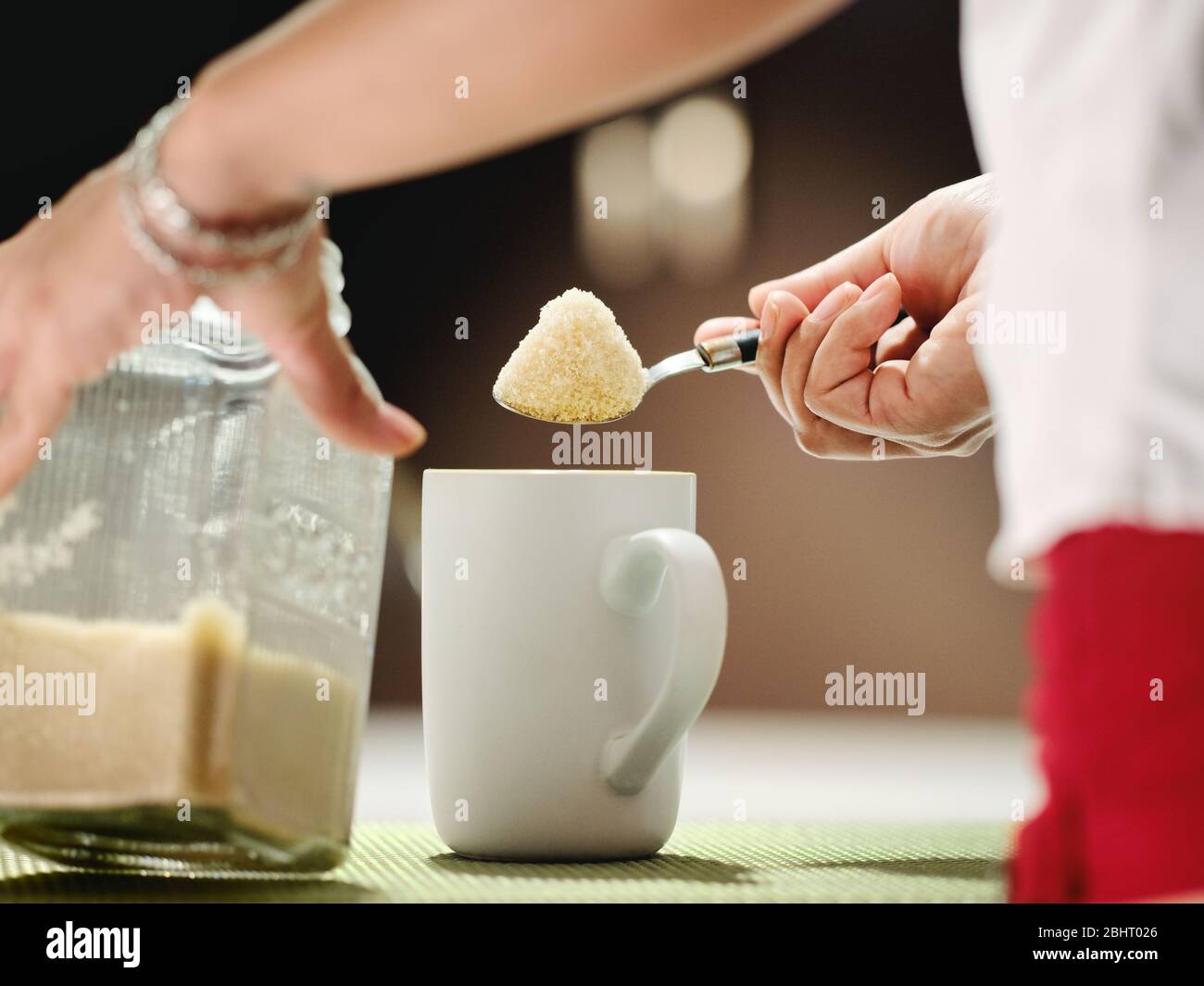 Woman Adding Lots Of Sugar With Teaspoon To Coffee Mug Stock Photo
