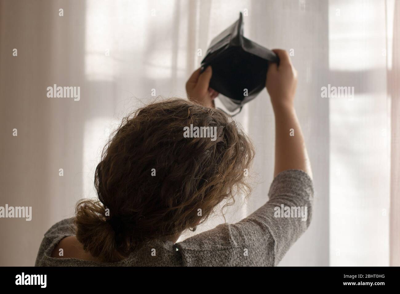 Empty black wallet in the hands of a young girl, the theme of poverty ...