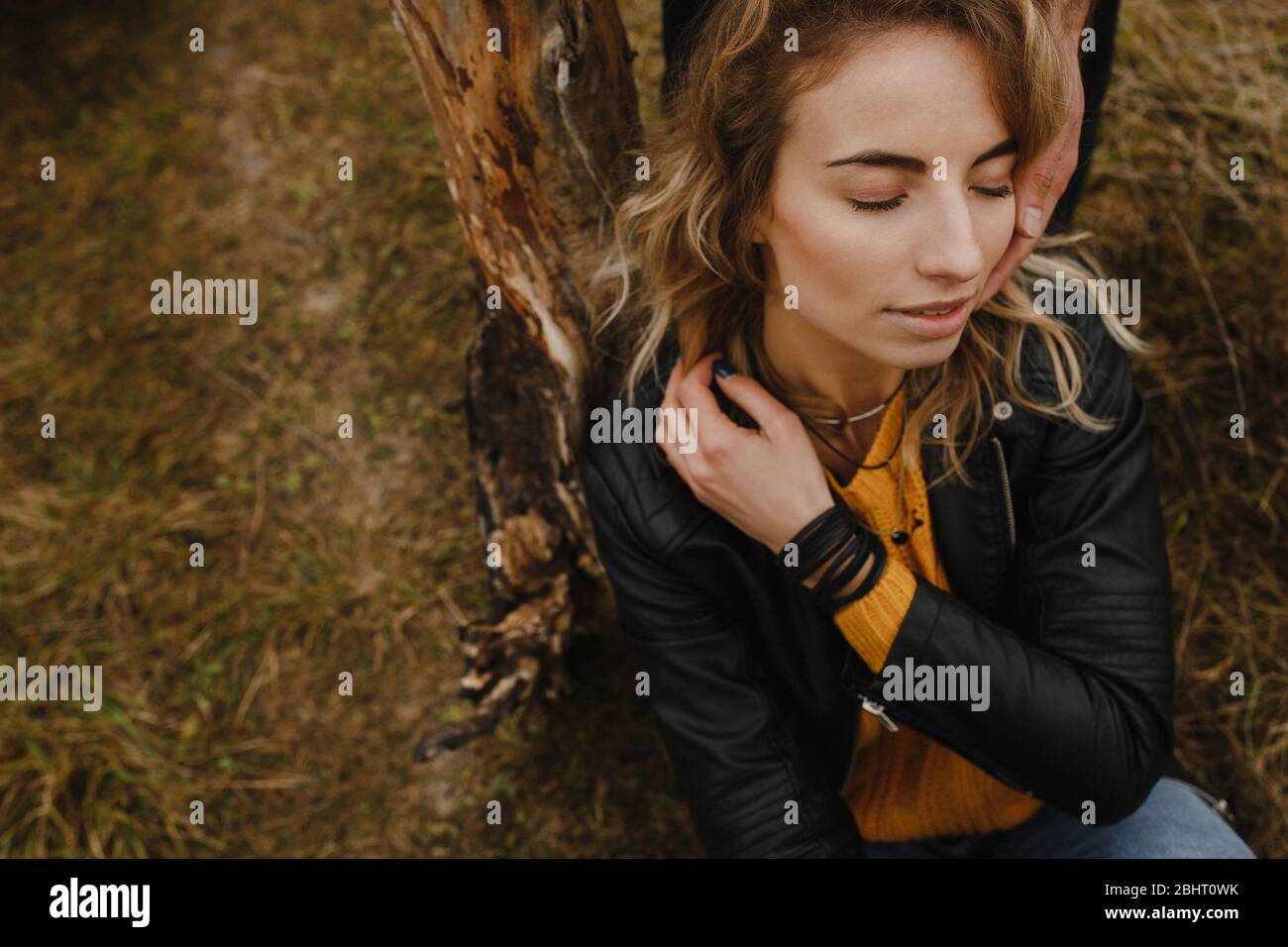 Woman sitting with closed eyes on the grass Stock Photo - Alamy