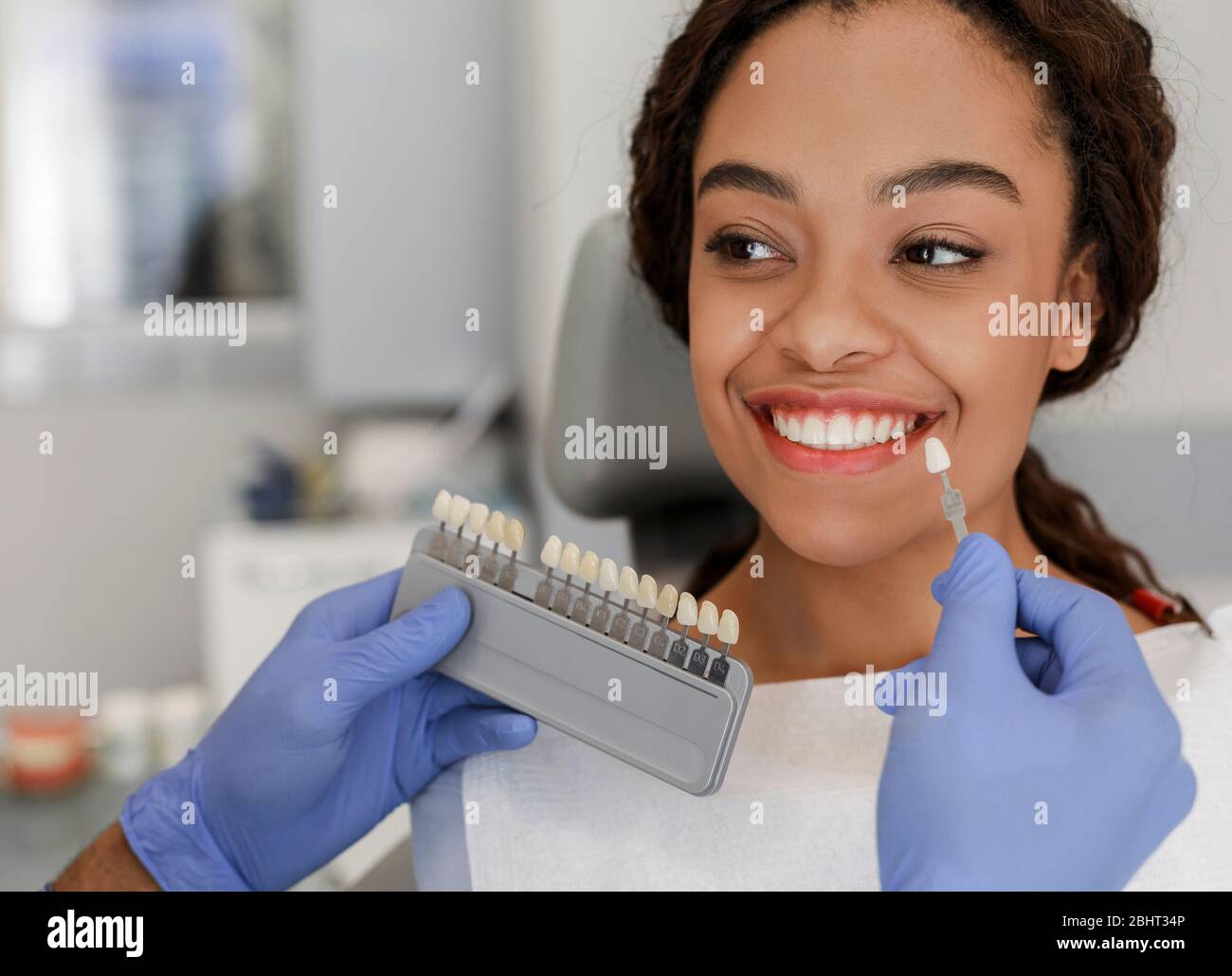 Dentist applying sample from tooth scale to patient teeth Stock Photo