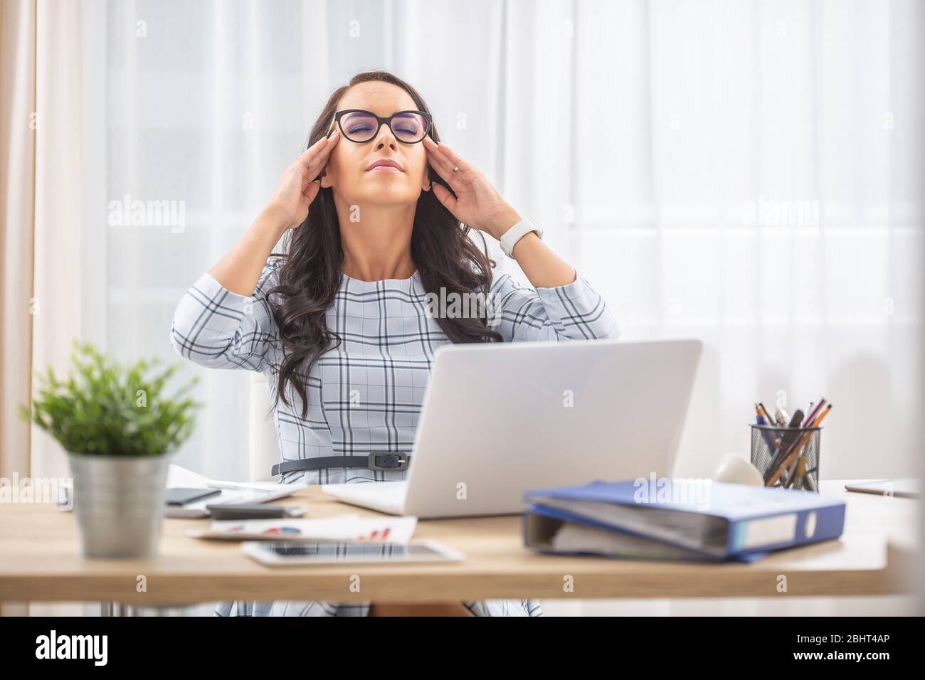 Woman fingers on temples hi-res stock photography and images - Alamy