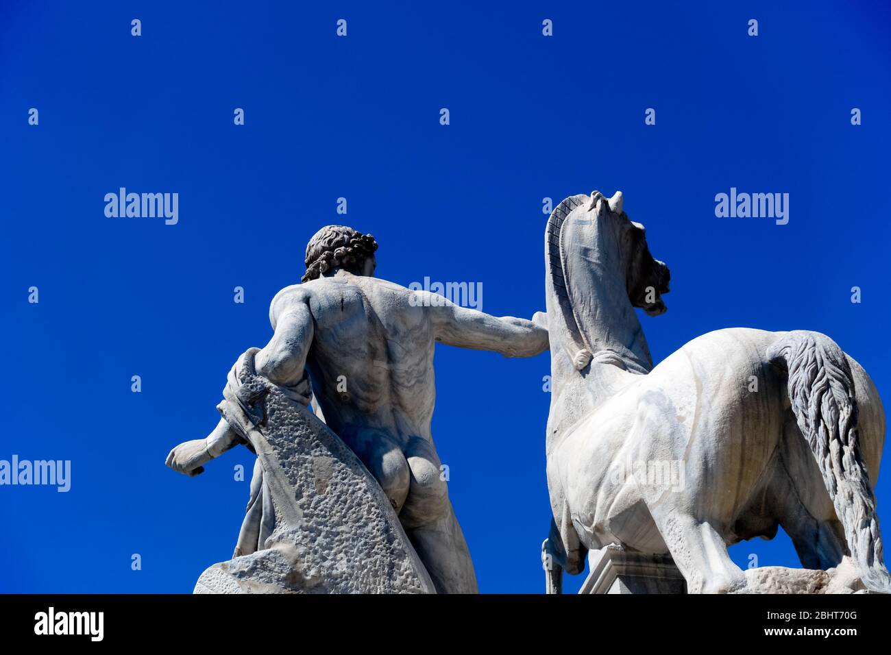 Dioscurus fountain detail: Dioscurus statue and horse. Quirinal Square. Italian Republic. Rome, Italy, Europe. Cloudless clear blue sky, copy space. Stock Photo