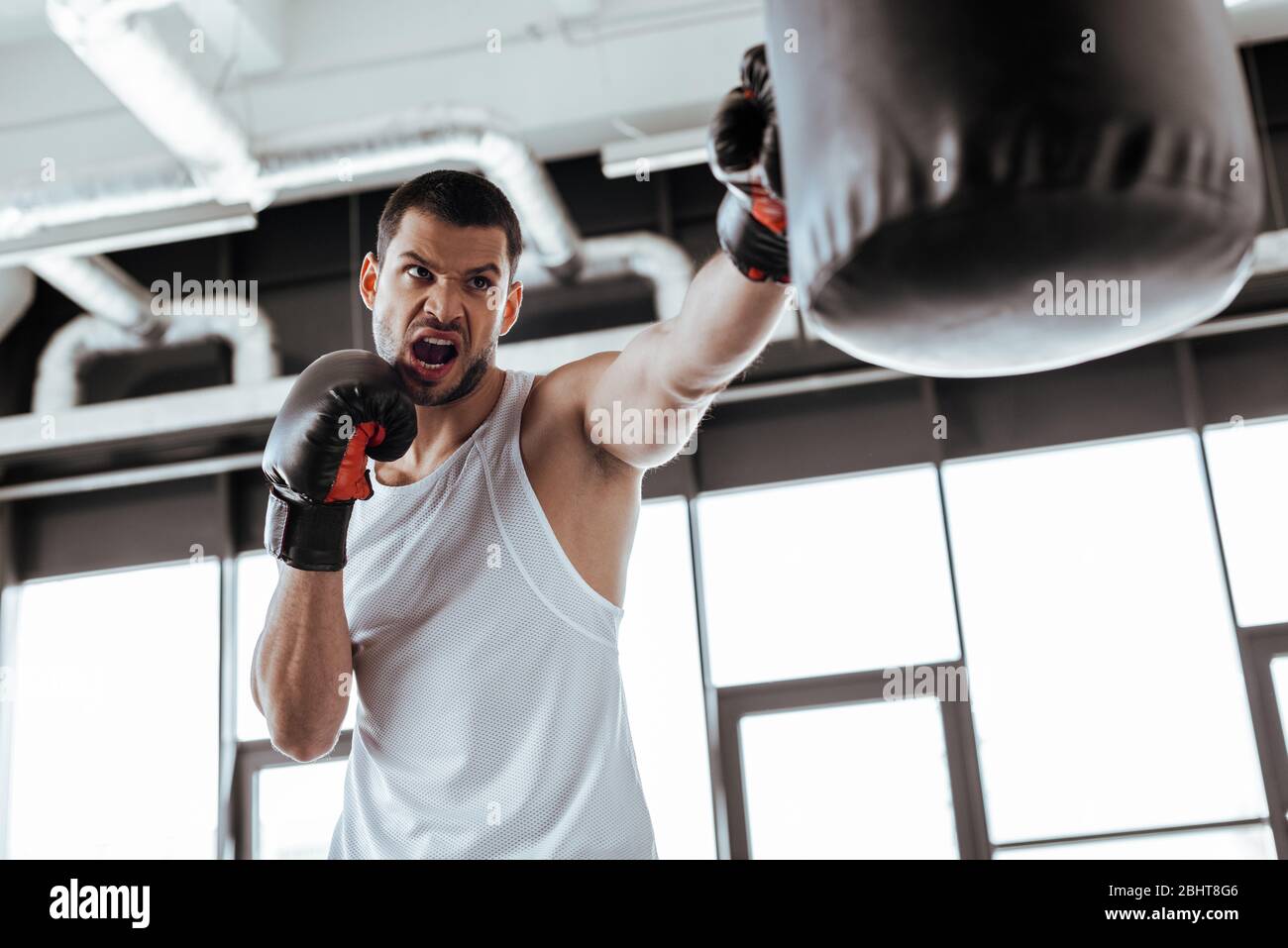 Angry man training punch bag hi-res stock photography and images - Alamy