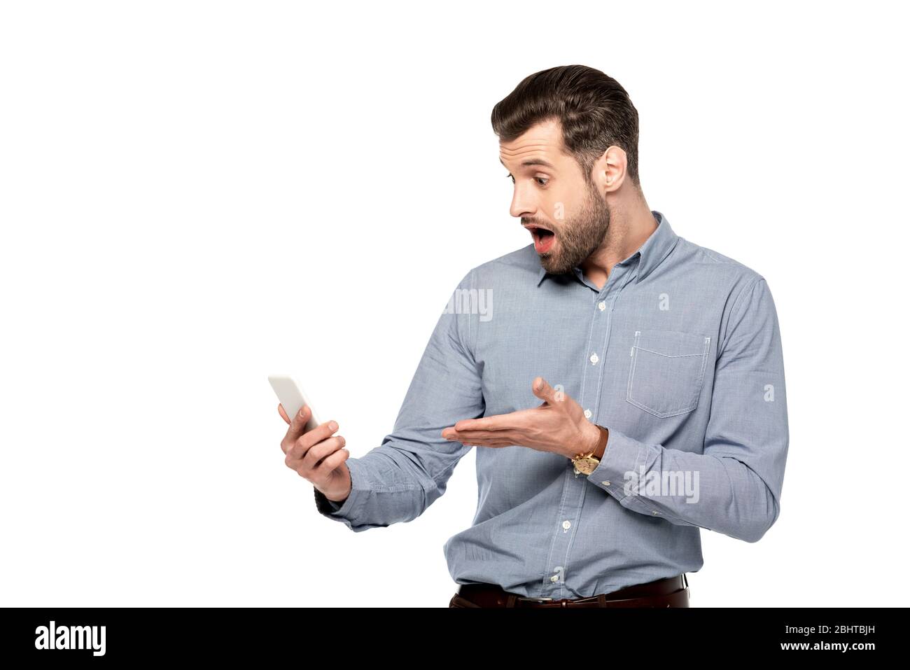 shocked businessman pointing with hand at smartphone isolated on white ...