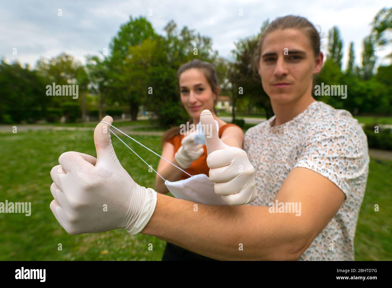 End of coronavirus, covid-19 pandemic. Couple throws away medical mask. Stock Photo