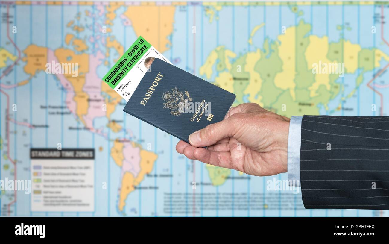 Senior man arm in suit and hand holding a USA passport with a coronavirus immunity certificate against global map Stock Photo