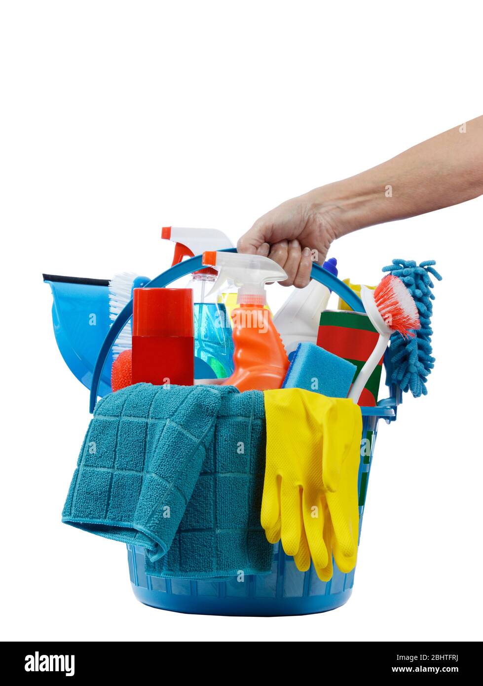 Vertical shot of a female hand holding a round blue plastic basket of cleaning supplies. White background. Stock Photo