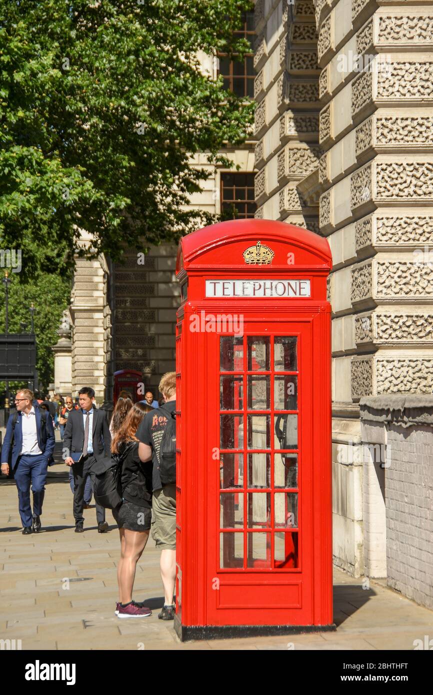 LONDON, ENGLAND JULY 2018 Traditional red telephone box on a street