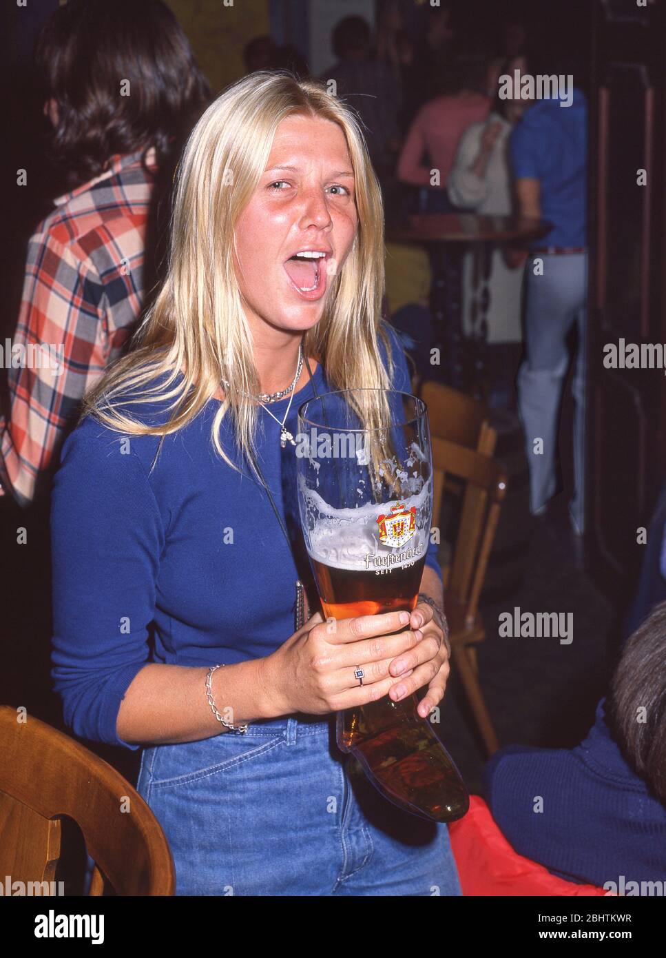 Young woman with beer boot in Beer Hall, Munich (Munchen), Bavaria, Federal Republic of Germany Stock Photo