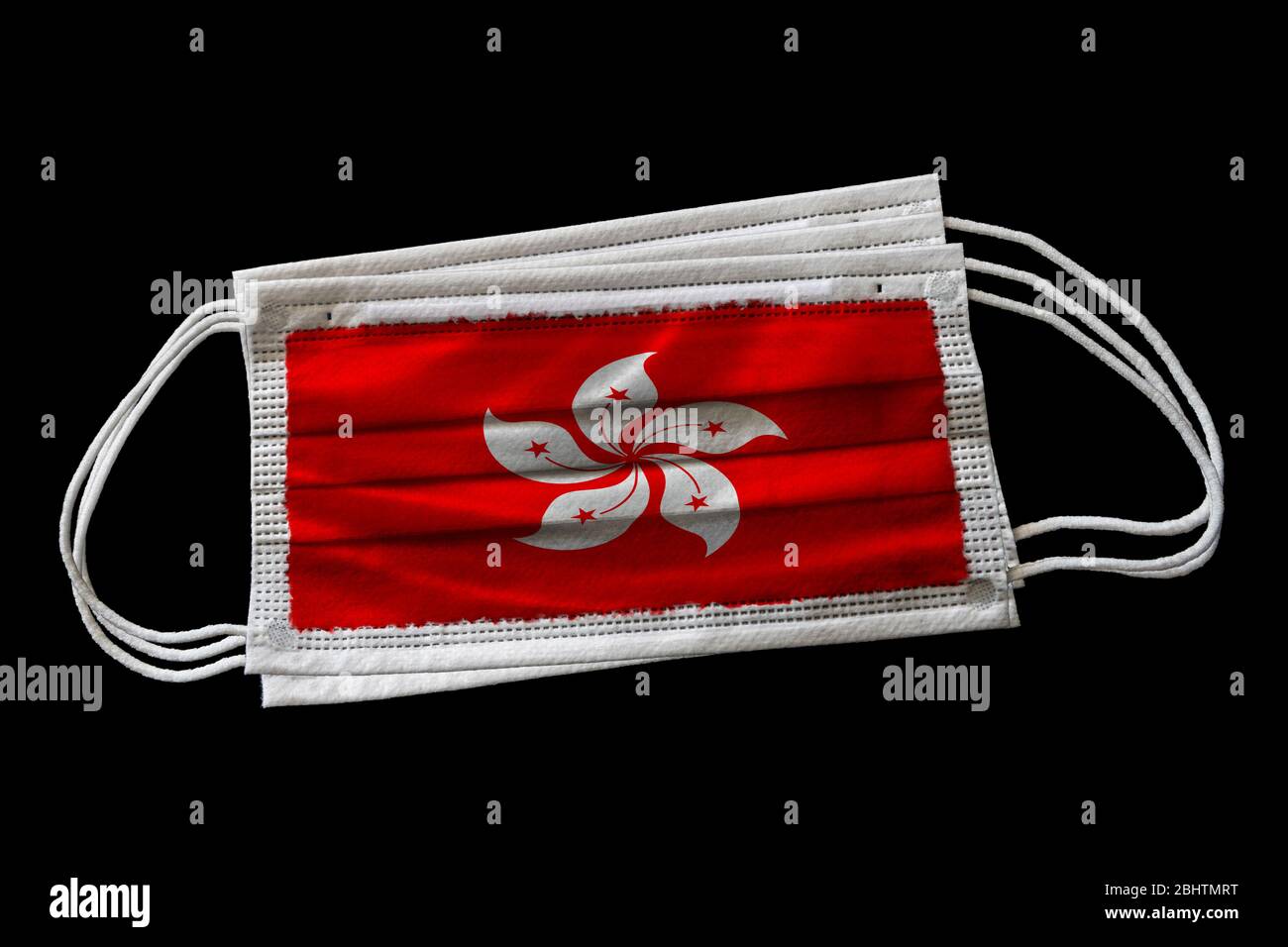 Surgical face masks with Hong Kong flag printed. Isolated on black background. Concept of face mask usage in Hong Kong SAR effort to combat Covid-19 c Stock Photo