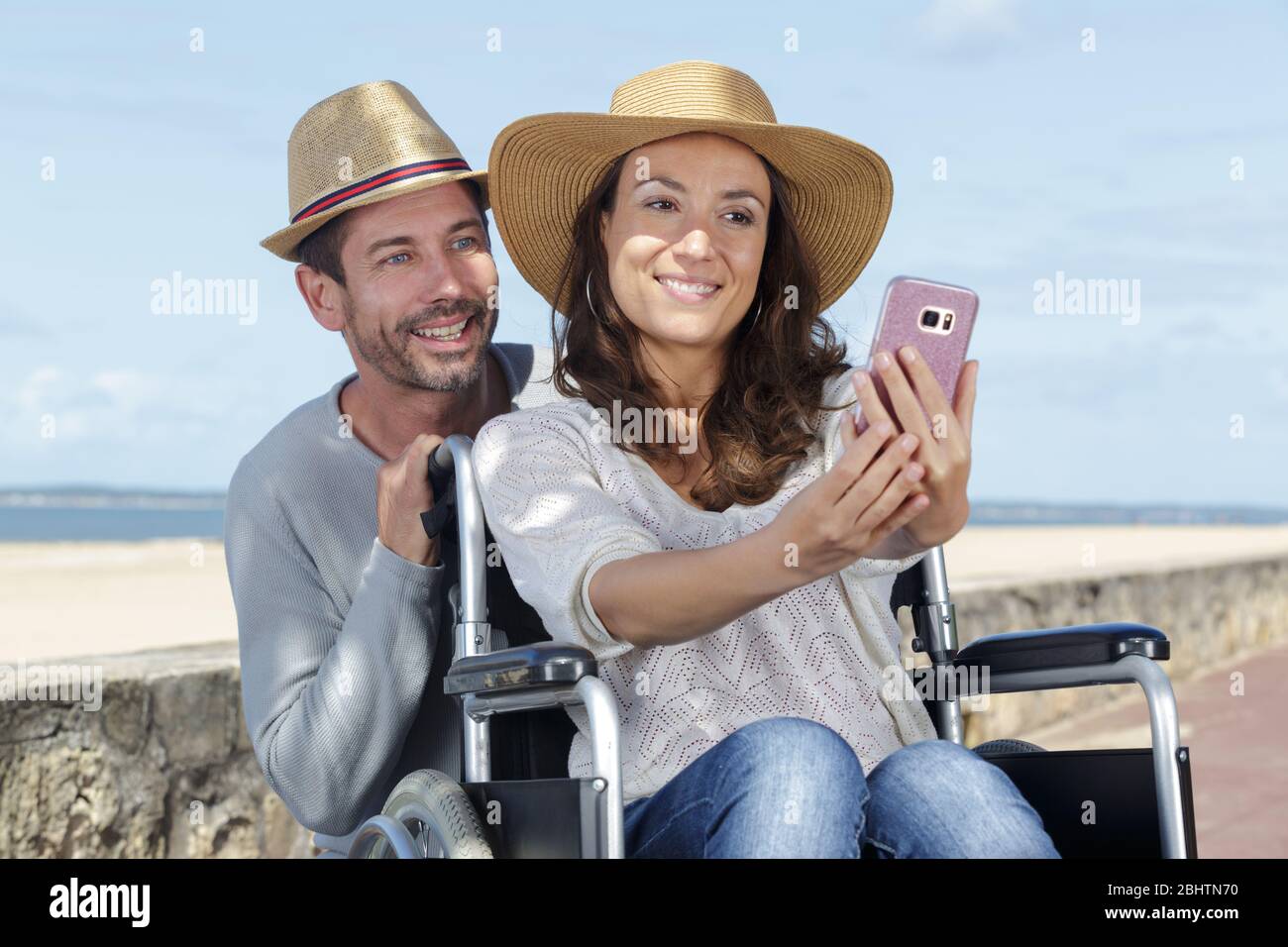 husband and woman in wheelchair doing a selfie Stock Photo - Alamy