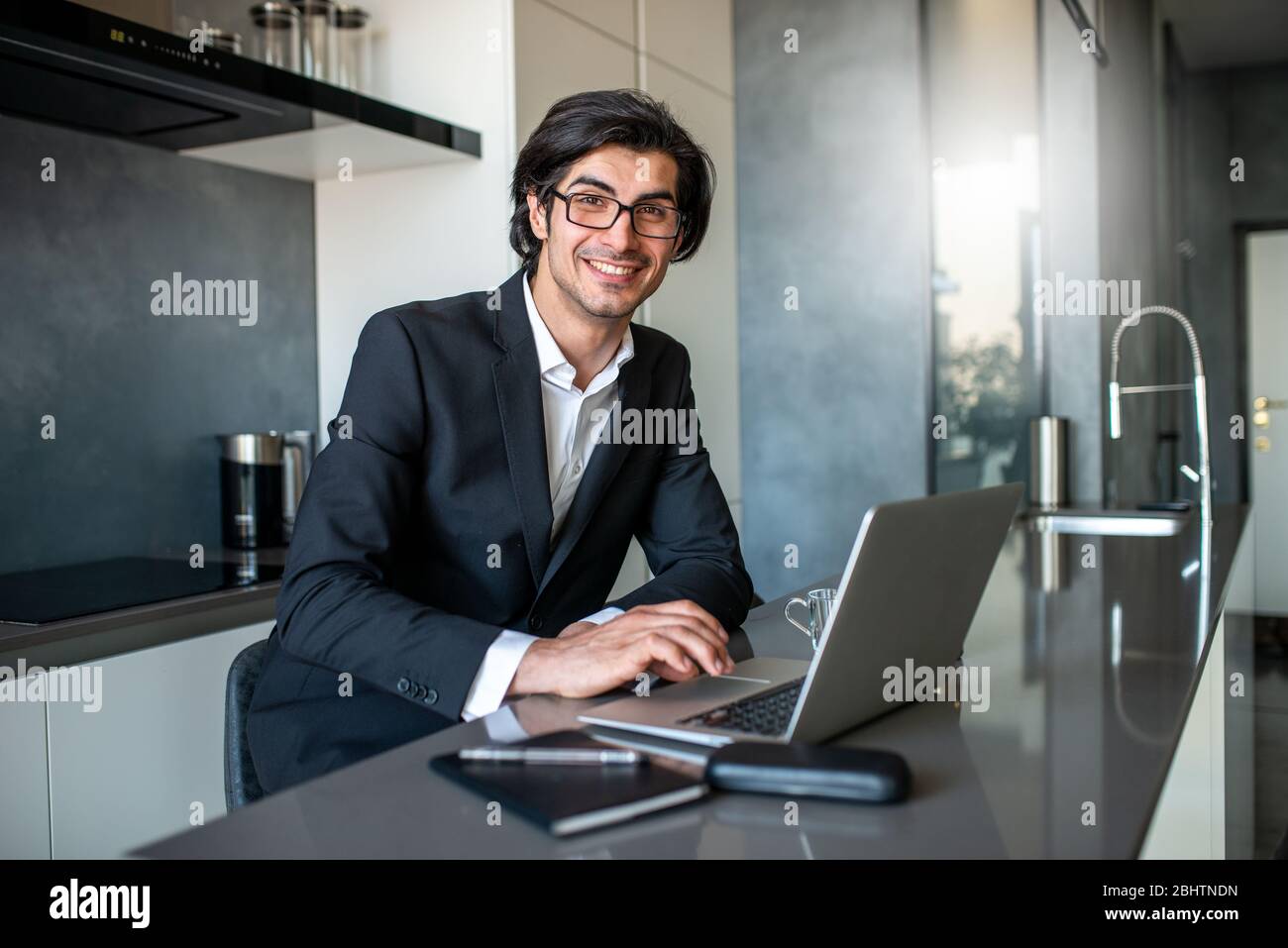 Businessman works from remote at house with a laptop due to coronavirus quarantine. Stock Photo