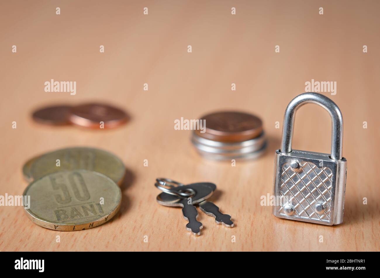 Lock and key on Romanian  coins  representing concept of financial control in the European Union. The economic future of Romania after the covid-19 cr Stock Photo