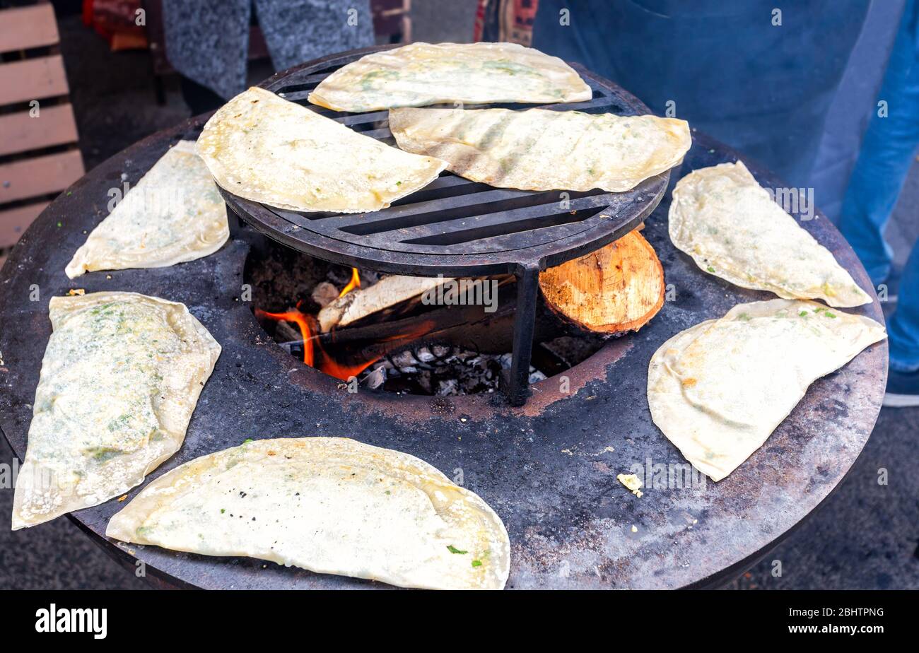 Cooking appetizing traditional uzbek pies outdoors. Uzbek cuisine. Asian cuisine. Concept of national cuisines Stock Photo