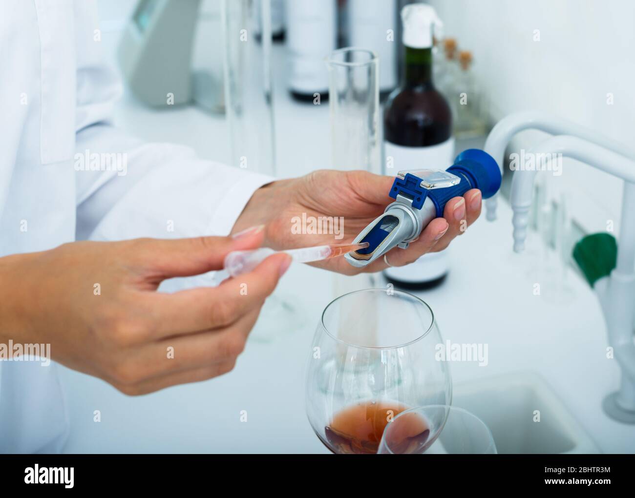 Close up on hands testing wine in chemical laboratory Stock Photo Alamy