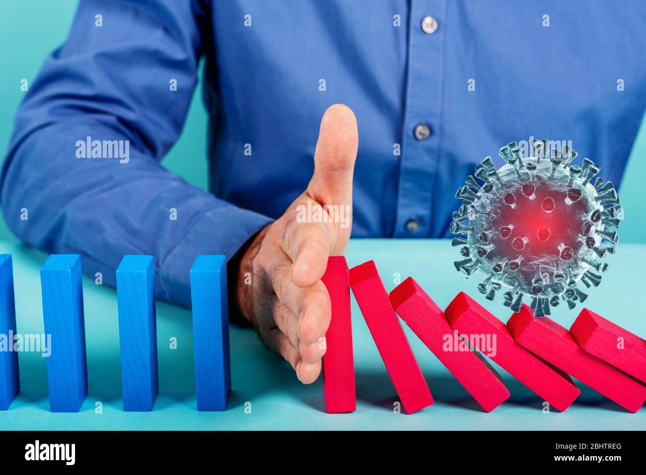 Concept of covid19 coronavirus pandemic with falling chain like a domino game. Contagion and infection progression stopped by a hand of a doctor. Cyan Stock Photo