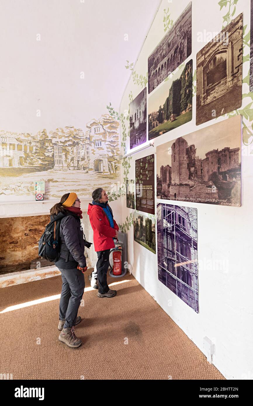 Visitors looking at museum display about the history of Raglan Castle, Wales, UK Stock Photo