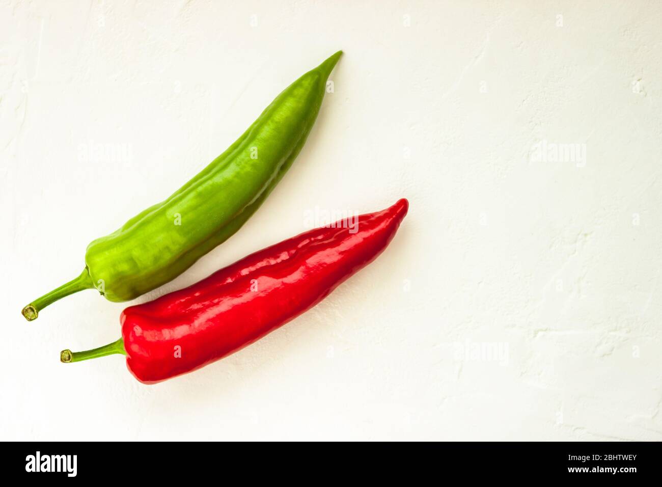 Red, green cayenne hot chili pepper on white background immune support healthy eating concept Stock Photo
