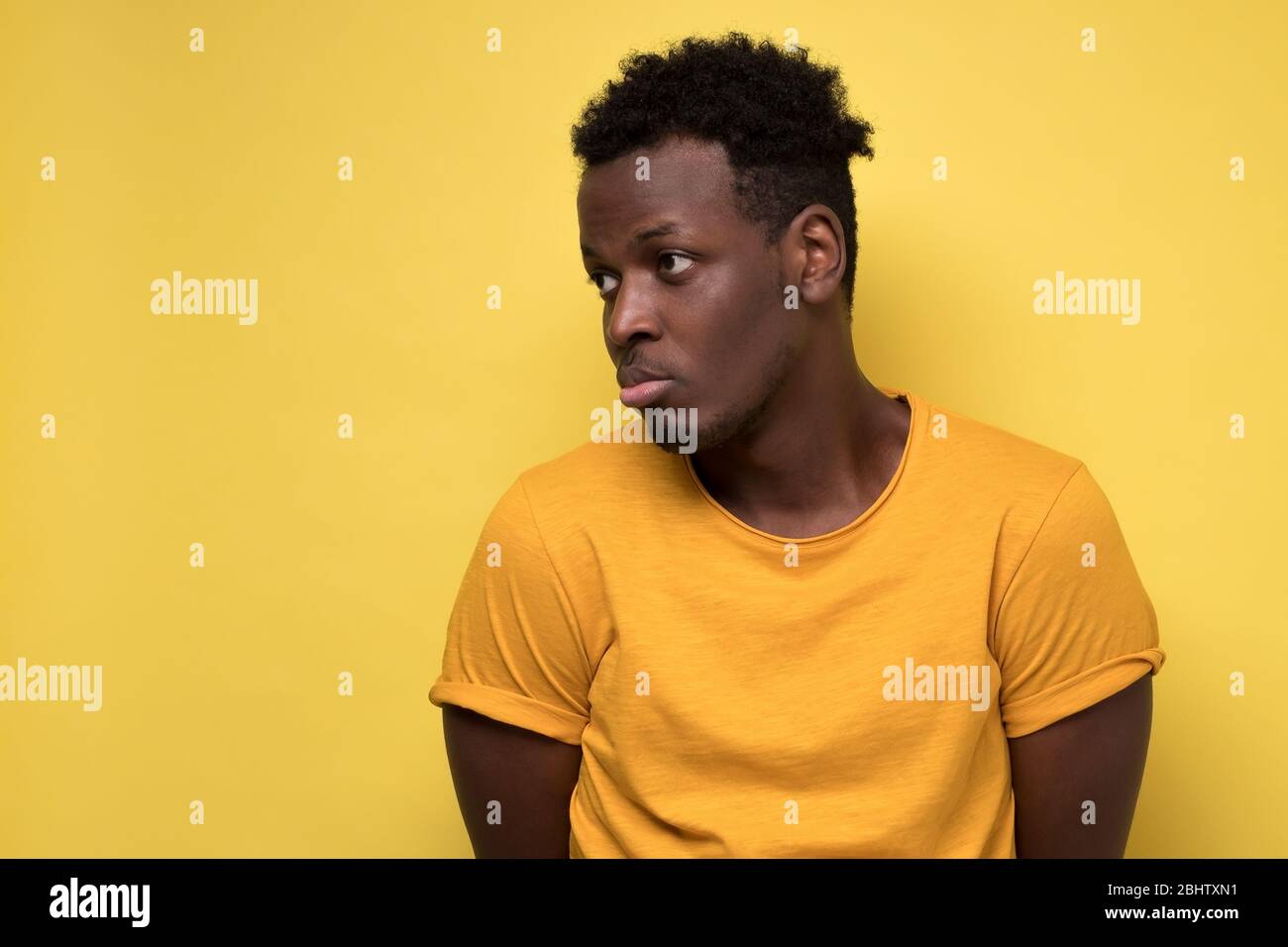 Young african american man looking down with guilty confused expression Stock Photo