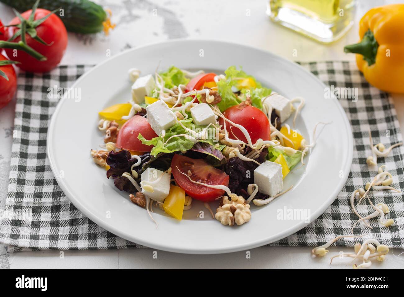 Fresh spring salad of vegetables, feta cheese and soybean sprout. Stock Photo